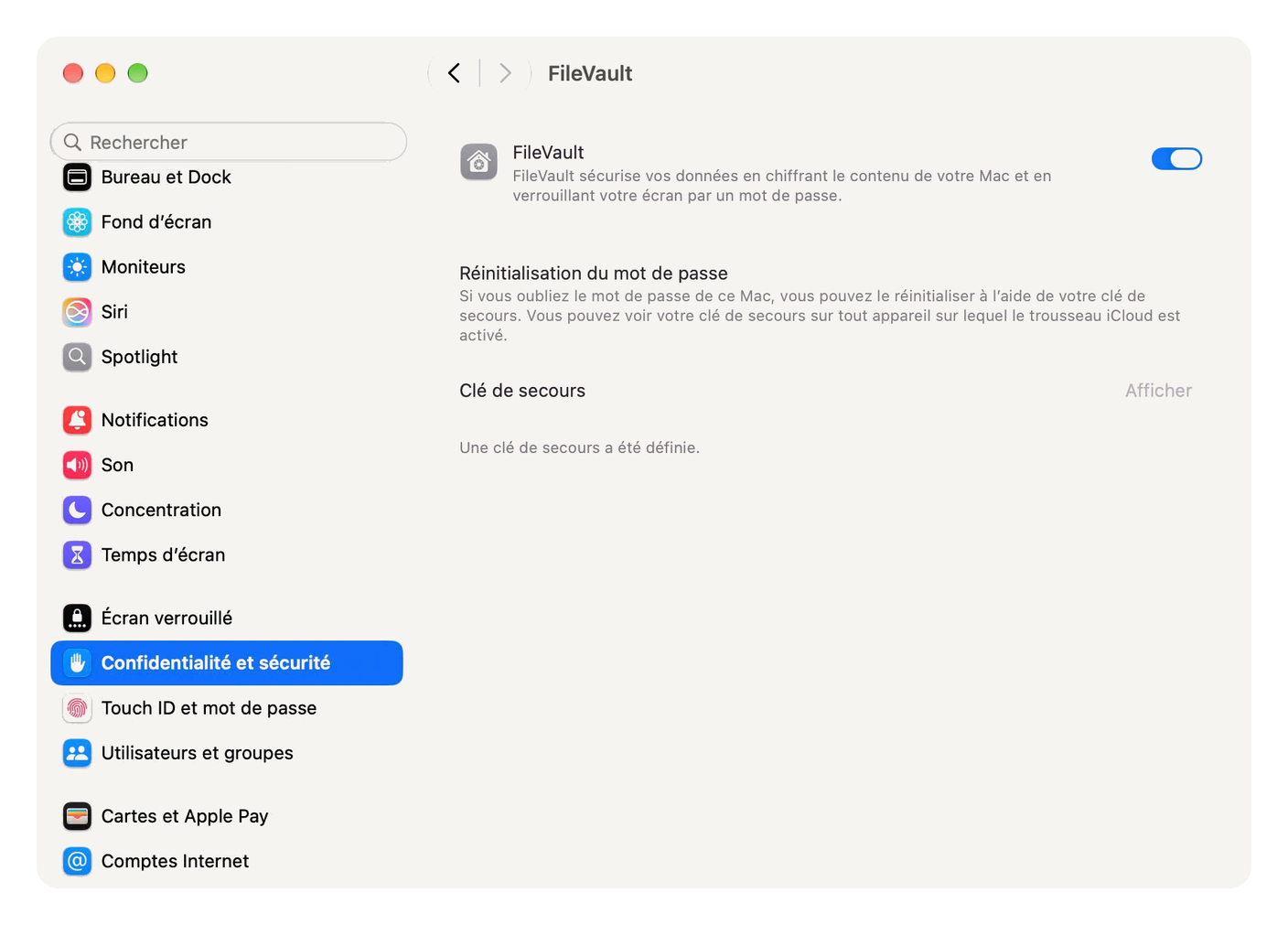 System Settings, FileVault on and a recovery key set, without showing it.